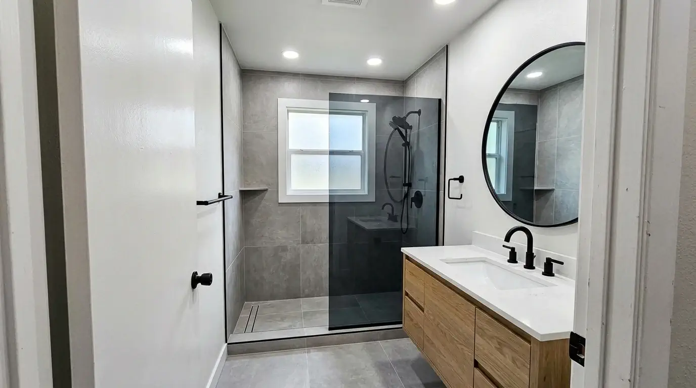 Renovated hall bathroom with tile shower after remodeling in Westbury, Houston